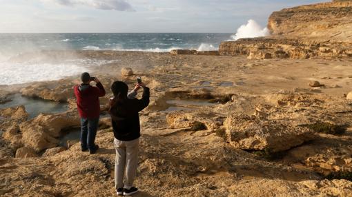 Dos personas fotografían la zona donde estaba la Ventana Azul