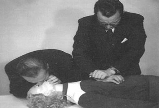 Asmund Laerdal and Bjorn Lind demonstrate CPR in the original Resusci Anne