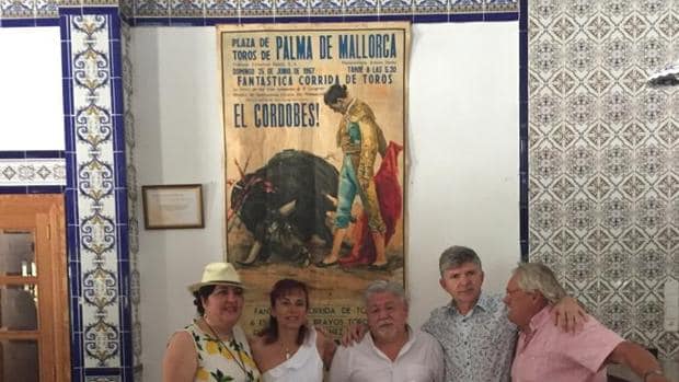 Miembros de la peña, con el presidente en el centro, posan junto a un cartel de toros en Palma