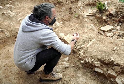 Ocharan examines a piece on the esplanade next to the sanctuary