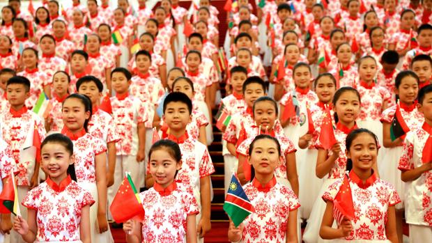 Un grupo de niños chinos con las banderas de cada país africano antes de la cumbre