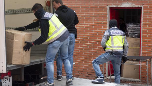 Los agentes se llevan ayer artículos robados de una vivienda del Pozo, tras el registro