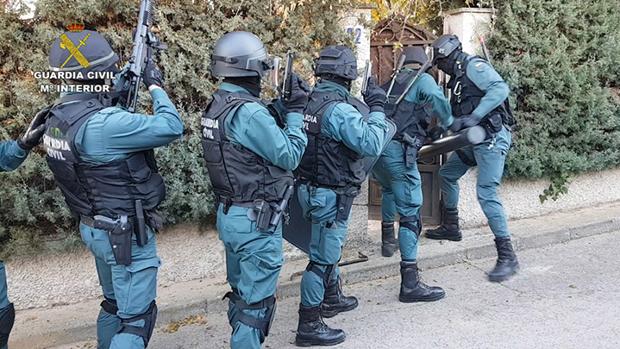 Agentes de la Guardia Civil, entrando en una de las viviendas