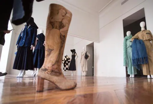 In the foreground, boots made from an ancient tapestry