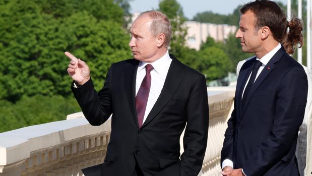 Vladimir Putin y Emmanuel Macron hablan durante una reunión en Rusia