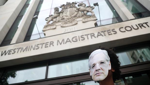Un hombre con una careta con el rostro de Julian Assange, ante el edificio de los tribunales de Westminster, donde se ha celebrado la audiencia preliminar
